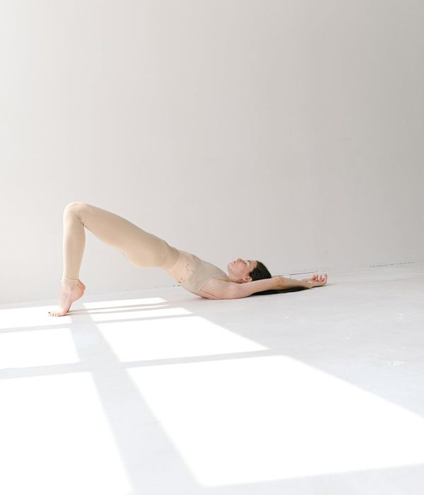 Pregnant woman in a serene yoga pose in a calm studio.